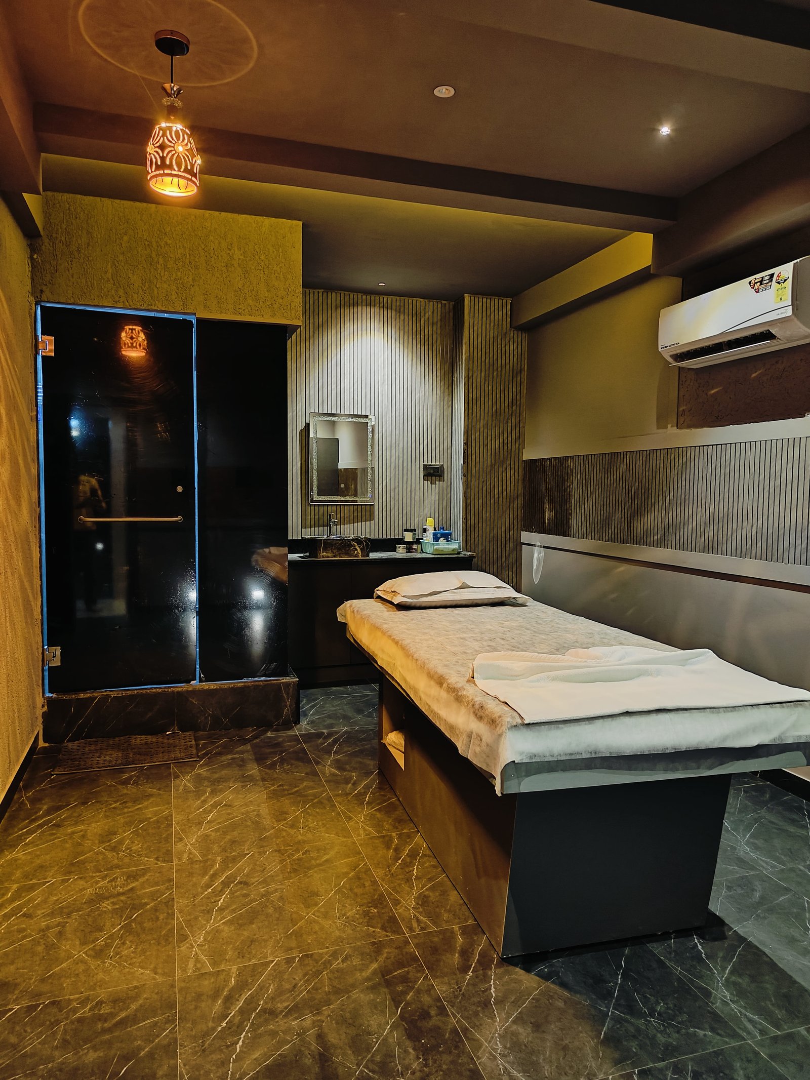 Modern spa room at Heritage Spawith soft lighting and comfortable massage tables