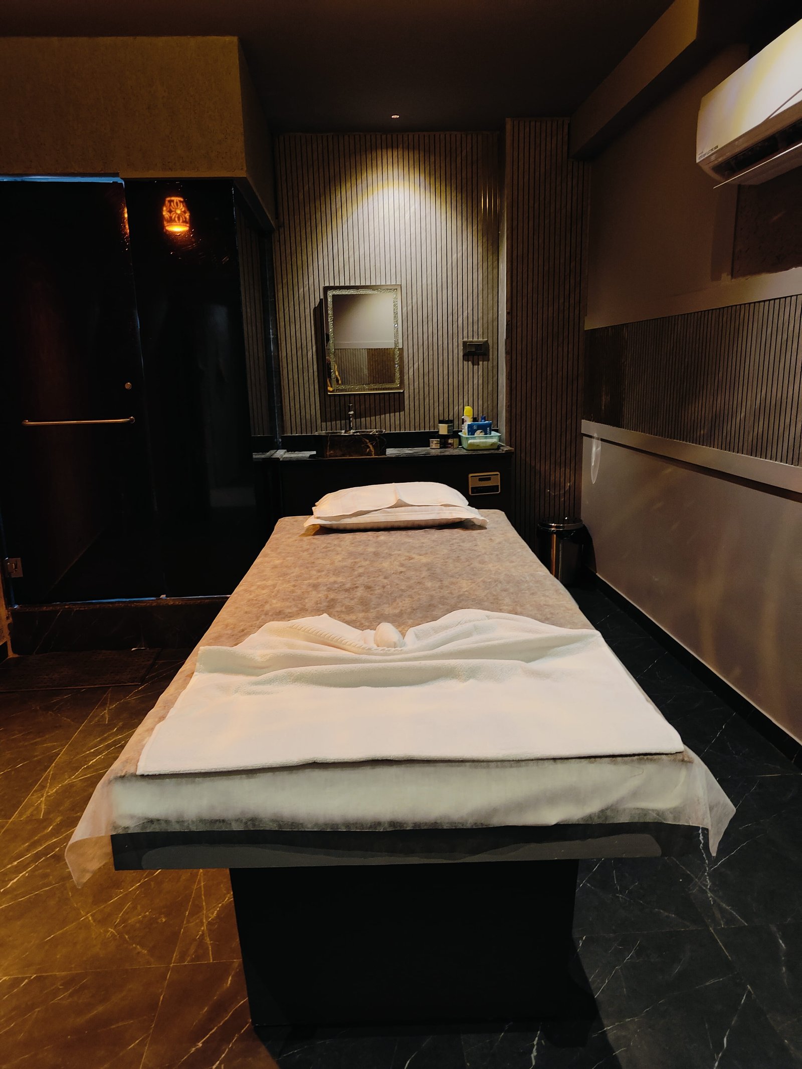 Modern spa room at Heritage Spawith soft lighting and comfortable massage tables