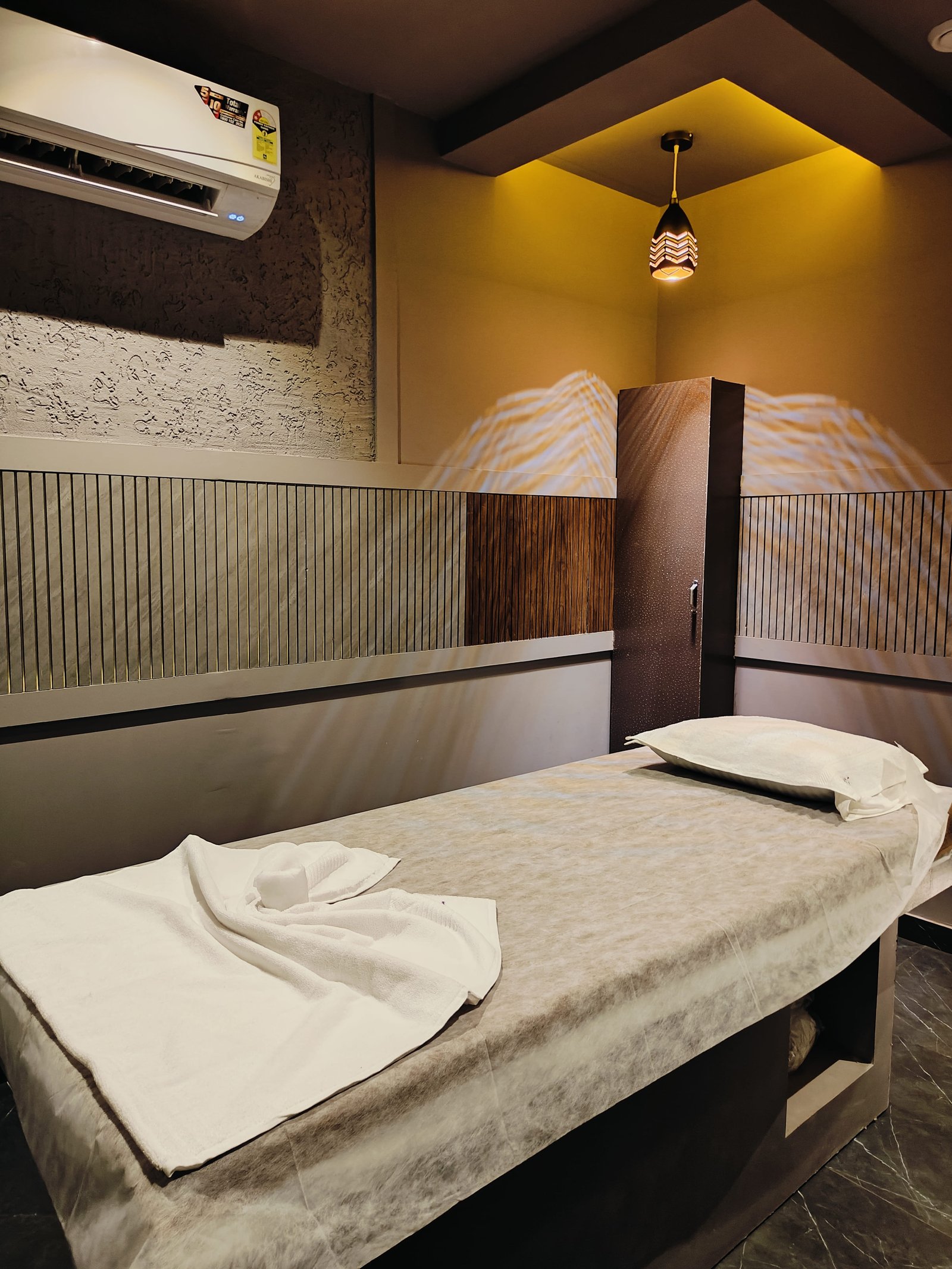 Modern spa room at Heritage Spawith soft lighting and comfortable massage tables
