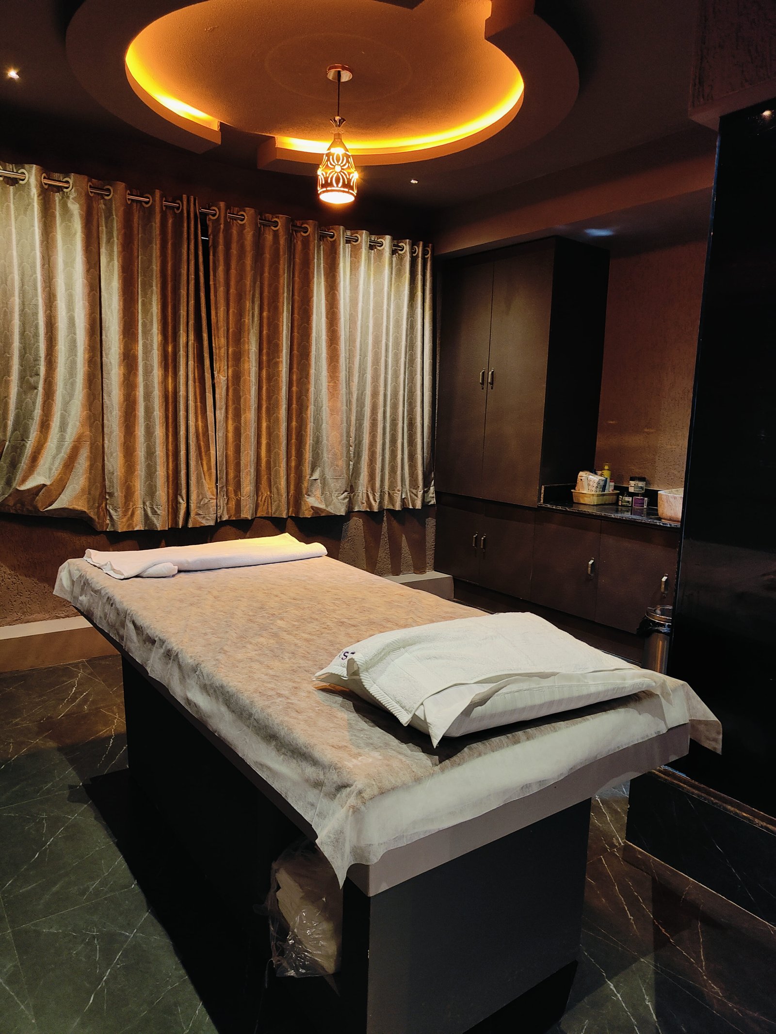 Modern spa room at Heritage Spawith soft lighting and comfortable massage tables